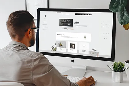 Professional designer creating a custom website layout for a New England construction company, focusing on brand identity and user experience.