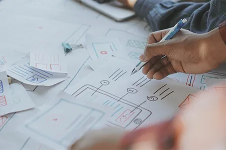 Strategic planning session for contractor web design, featuring digital tablets and construction blueprints to align marketing goals with business reality.